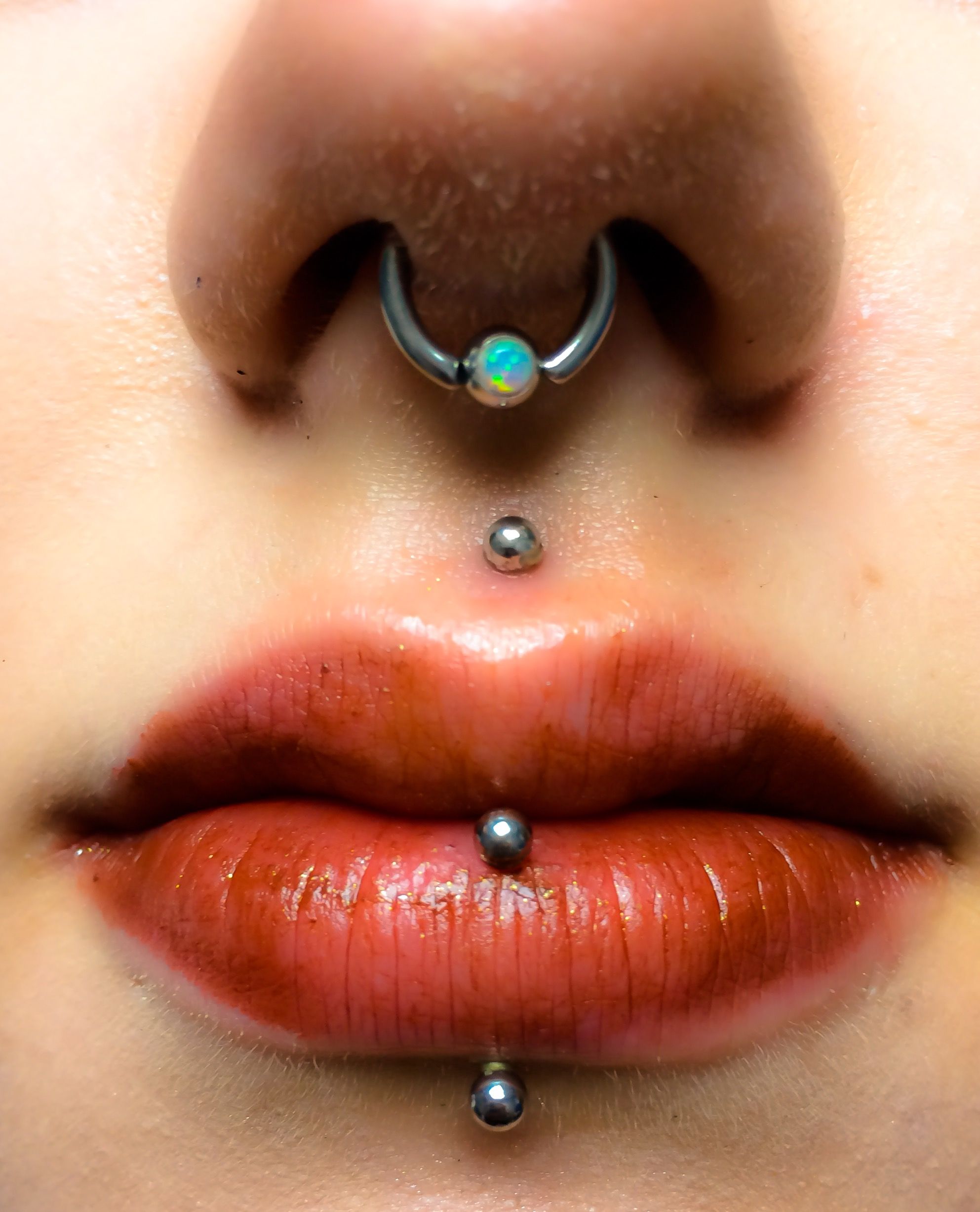 Vertical labret and medusa piercings