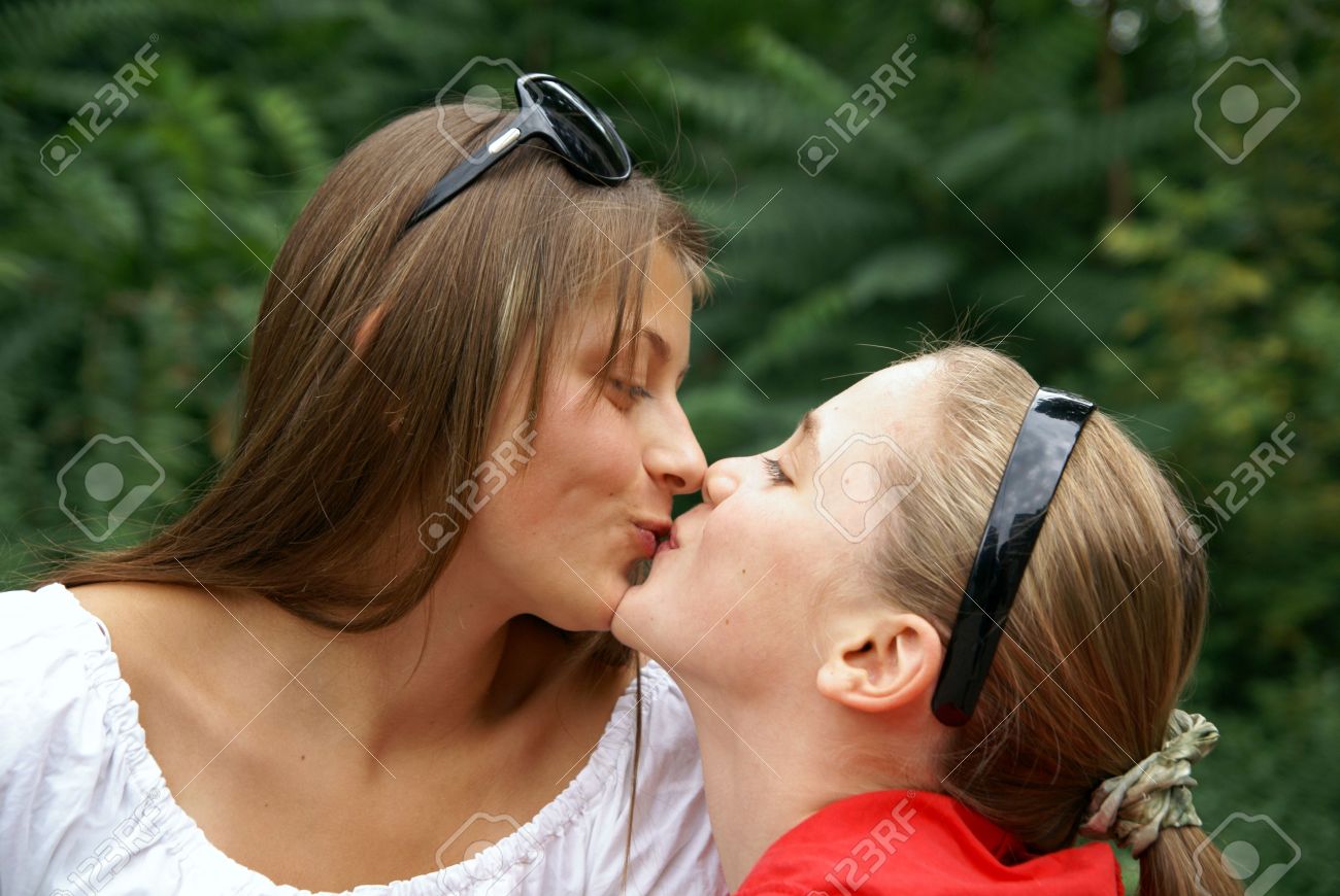 Teen girls kissing at a water park