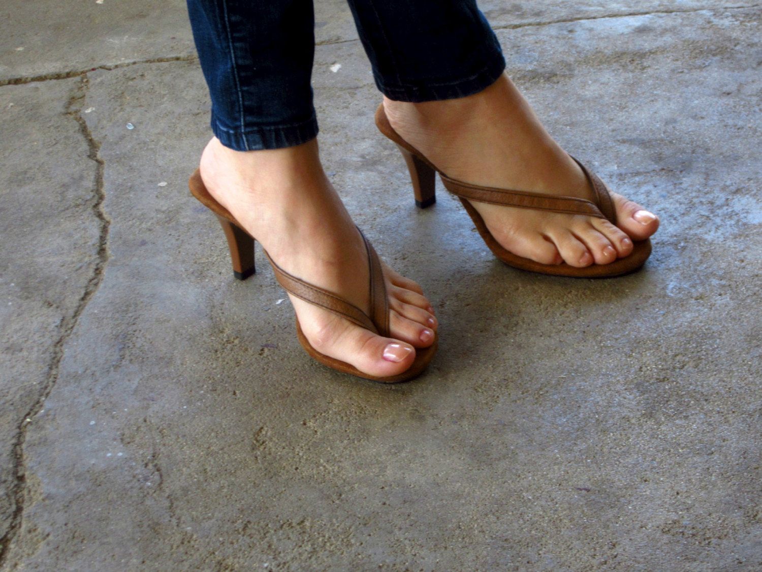 Feet in high heels thong sandals