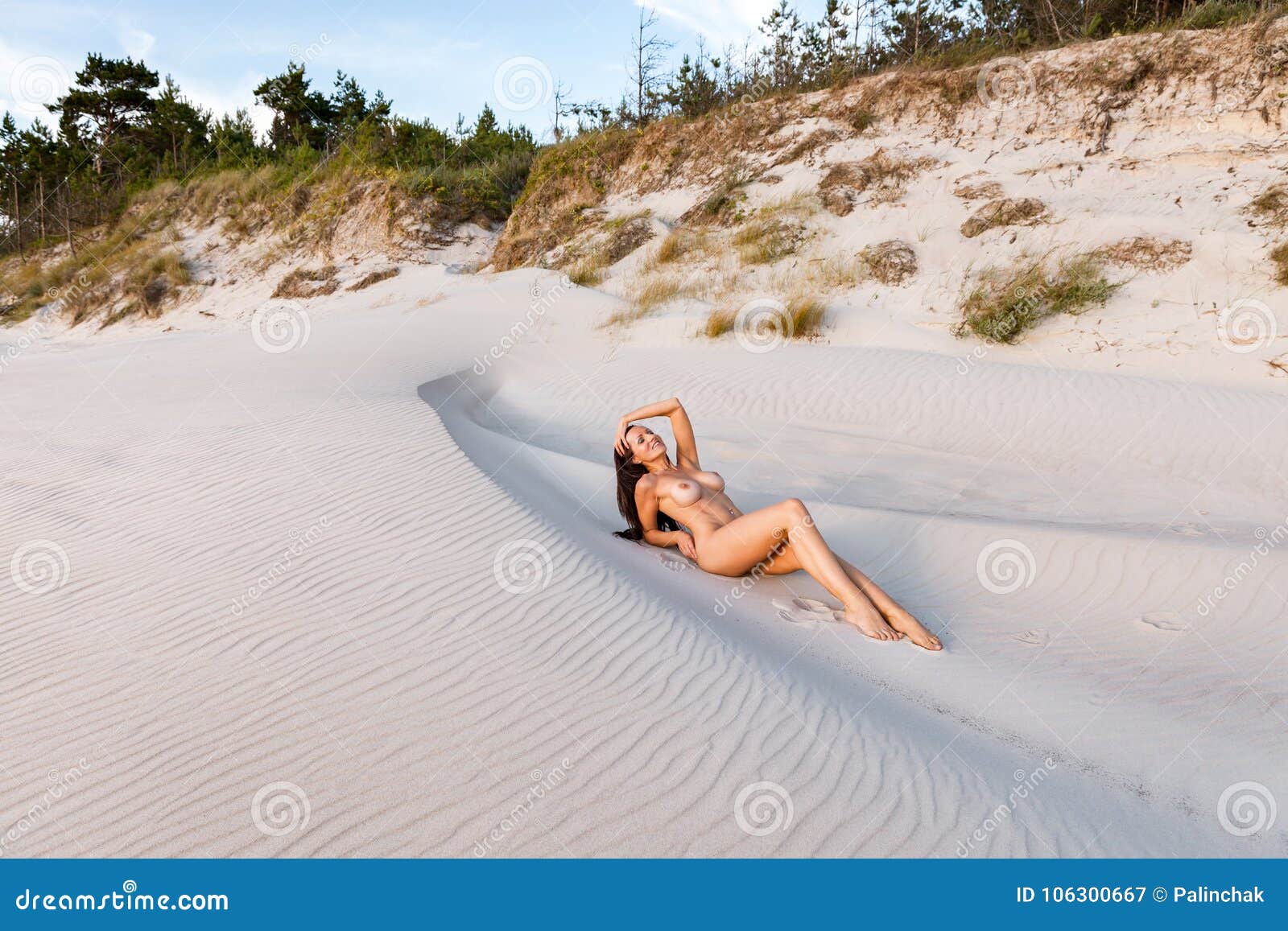 Nude girl sun tanning on beach