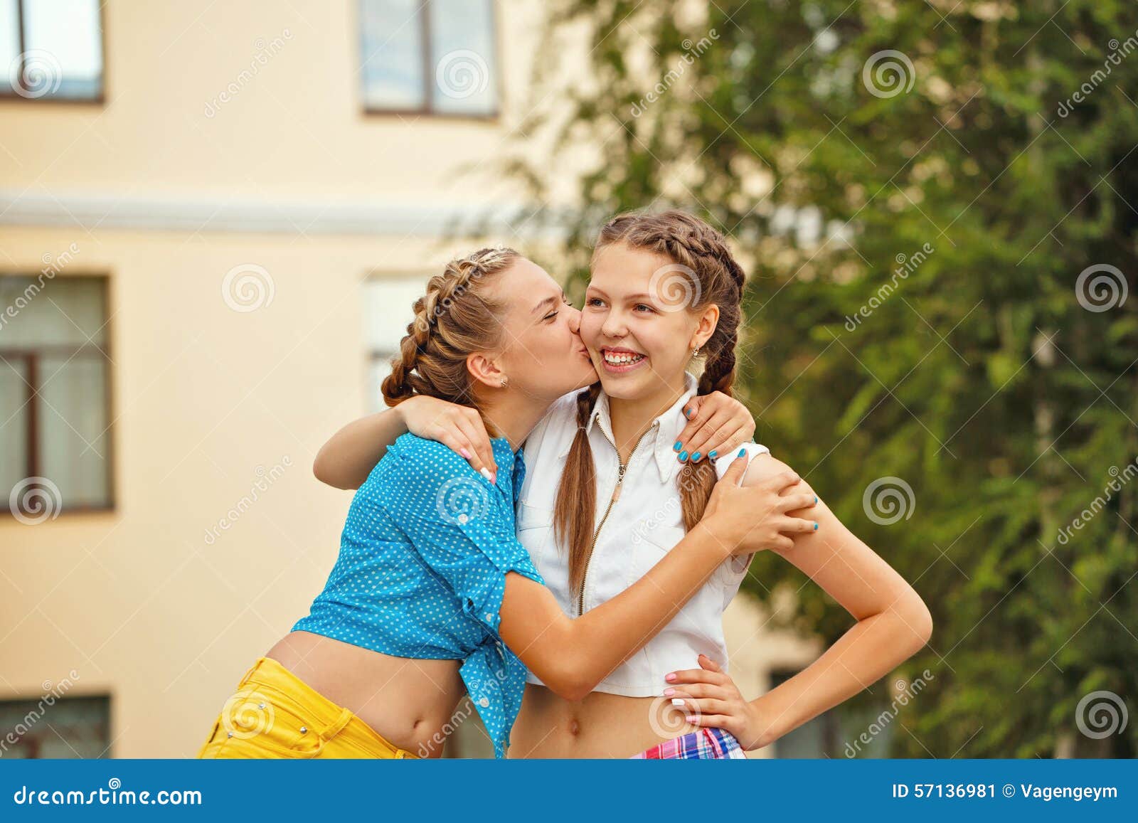 Teen girls kissing at a water park